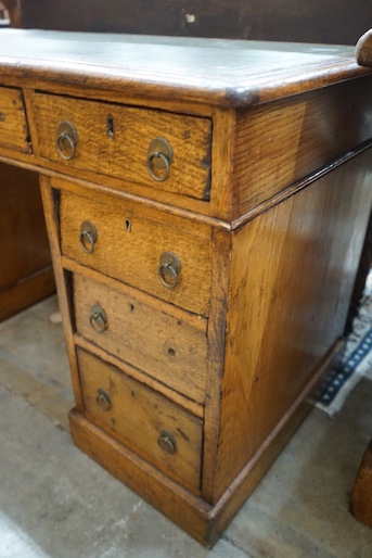 A Victorian light oak pedestal desk, fitted nine small drawers, width 120cm, depth 59cm, height 72cm